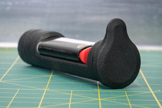 Image: The Climb Switch High Performance System, a discreet and practical bike accessory, discreetly stores a custom machined one-hitter, a Mini BIC lighter, and a small amount of material inside your bike's steerer tube. Designed to seamlessly integrate with the OneUp EDC top cap system, it is crafted in BC, Canada using 3D printed MJF nylon and 6061 aluminum materials, ensuring a lightweight, durable, and inconspicuous addition to your bike. product top closeup.