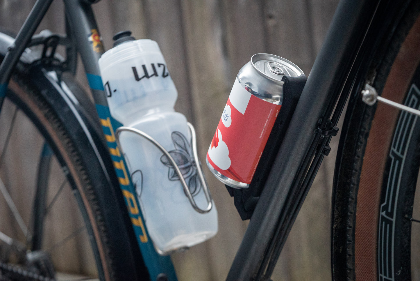 Image: The Canclaw, a lightweight and low-profile bike drink holder designed for standard 12oz (355ml) cans and 16oz (473ml) tall cans. It securely grips your beverage and can be attached using standard bottle cage bolt spacing or zipties. This product is 3D printed to order from ultra-strong carbon fiber nylon material and proudly made in Canada. Front angle.